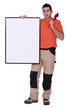 Handyman holding wrench over shoulder