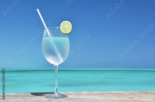 Photo: Glass of water against ocean Glass of water against ocean