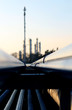 Photo: long pipe and silhouette of oil refinery long pipe and silhouette of oil refinery