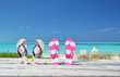 Two pairs of flip-flops against ocean. Exuma, Bahamas