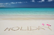HOLIDAY writing on the sandy beach of Exuma, Bahamas
