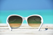 Sunglasses against tropical ocean