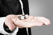 Photo: A male model showcasing cuff links in his hand A male model showcasing cuff links in his hand