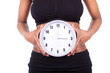 Young black african american woman holding a clock in front of h
