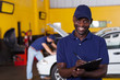 Photo: african american male vehicle mechanic writing report african american male vehicle mechanic writing report