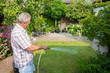 Senior man watering his garden