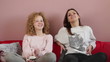 Young smiling girls watching TV together