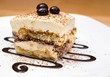 Tiramisu cake and chocolate swirl on white plate