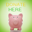 Piggy bank with donate here text