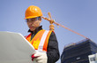 construction worker with crane in background
