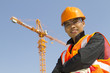 construction worker with crane in background