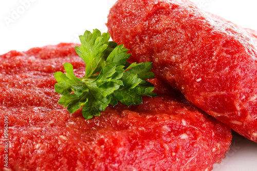 Photo: Raw beef and vegetables on white background Raw beef and vegetables on white background