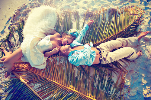 Photo: Wedding couple lying on palm leaf Wedding couple lying on palm leaf