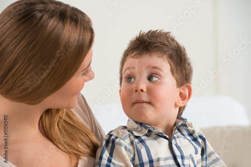 Photo: Happy mother talking to her son at home Happy mother talking to her son at home