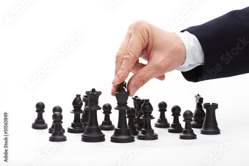 Photo: Business man moving chess figure Business man moving chess figure