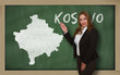Teacher showing map of kosovo on blackboard