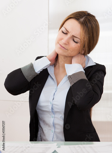 Photo: Young Attractive Businesswoman Suffer From Neck Pain Young Attractive Businesswoman Suffer From Neck Pain
