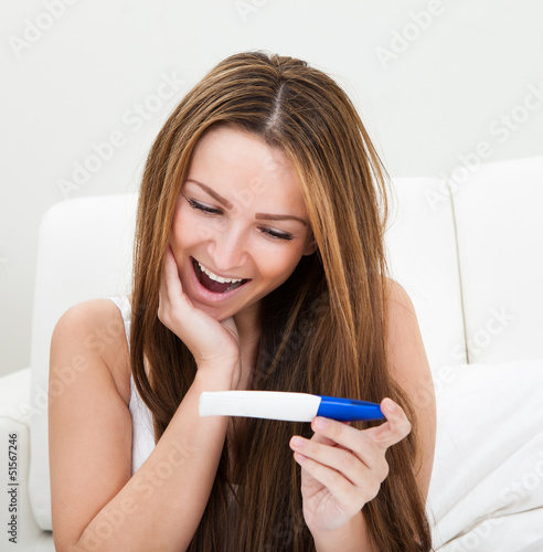 Photo: Woman Checking Pregnancy Test Woman Checking Pregnancy Test