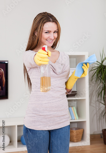 Photo: Young Woman Cleaning House Young Woman Cleaning House