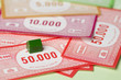 Green house and bank notes on monopoly game board