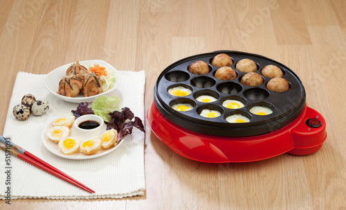 Photo: Takoyaki ball cooking machine display with takoyaki and fried eg Takoyaki ball cooking machine display with takoyaki and fried eg
