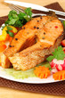 Appetizing grilled salmon with vegetables close up