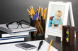 Photo: White photo frame on office desk on grey background White photo frame on office desk on grey background