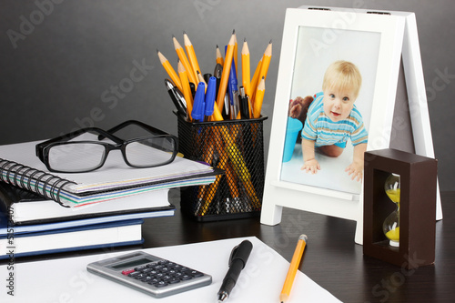 Photo: White photo frame on office desk on grey background White photo frame on office desk on grey background