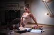 young woman sitting and reading magazine indoor shot