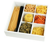 Different types of pasta in white wooden box sections isolated