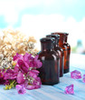 Spa oil and freesia on light background