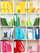 White office shelves with different stationery, close up