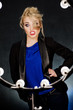 Young beautiful blonde on the dark background in the light of la