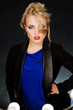 Young beautiful blonde on the dark background in the light of la
