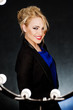 Young beautiful blonde on the dark background in the light of la