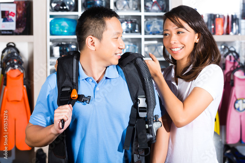 Photo: Customer buying equipment in divers shop Customer buying equipment in divers shop