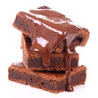 Photo: Slices of a brownie on white coverd with chocolate Slices of a brownie on white coverd with chocolate