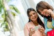 Zdjęcie: Happy women with a mobile phone Happy women with a mobile phone