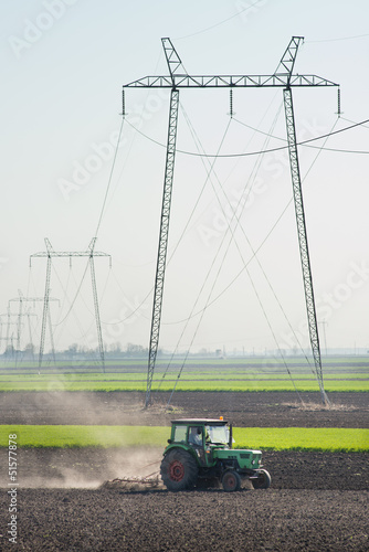 Photo: Tractor plowing the fields Tractor plowing the fields