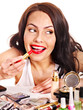 Foto: Girl applying makeup. Girl applying makeup.