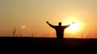 Silhouette of man on the sunrise. Freedom concept.