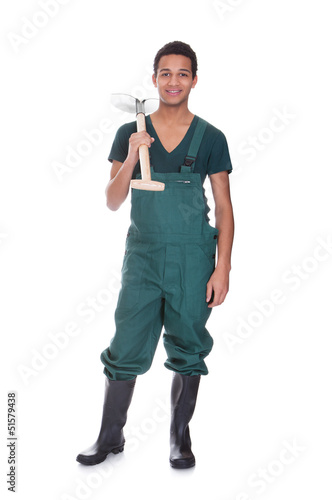 Photo: Happy young gardener in dungarees Happy young gardener in dungarees