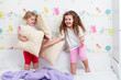 kids sisters playing on the bed indoors