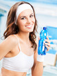 Woman with bottle of water, at fitness club