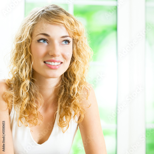 Photo: Smiling young beautiful woman, indoors Smiling young beautiful woman, indoors