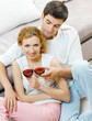 Cheerful couple with glasses of redwine