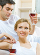 Cheerful couple with glasses of redwine