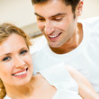 Cheerful smiling young couple, indoors