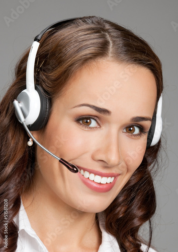 Photo: Support phone operator in headset, on gray Support phone operator in headset, on gray