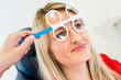 Optometry concept - pretty young woman having her eyes examined